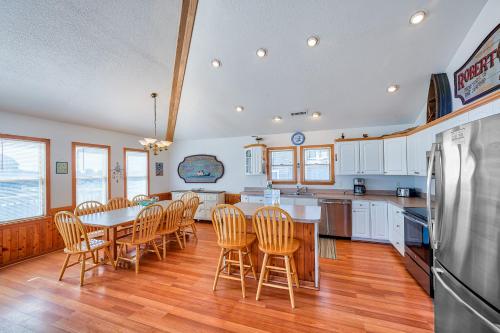 a kitchen with a table and chairs and a refrigerator at Captain's Quarters 125 in Rodanthe