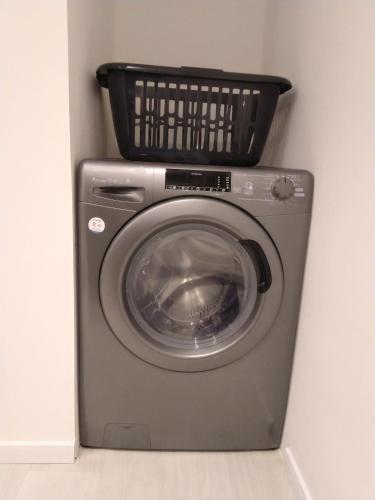 a washing machine with a basket on top of it at Studio neuf cosy La flèche in La Flèche
