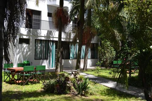 a building with a table and chairs and palm trees at Casablanca in Victoria