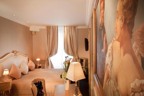 a bedroom with a bed and a large window at Hotel & Spa Saint-Jacques in Paris
