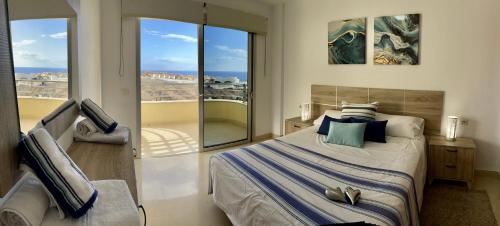 a bedroom with a bed and a balcony at Residencias Sol Paraiso in Adeje