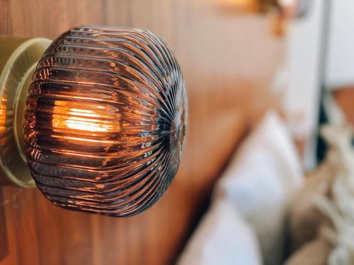 a wicker light bulb hanging from a wall at Minimi Inn-Sailrock Beach House in Eluan
