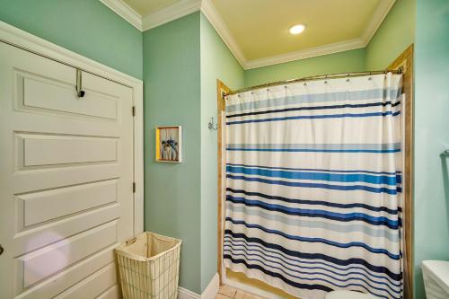 a bathroom with a shower with a striped shower curtain at Seas the Day 991 RR in Rodanthe