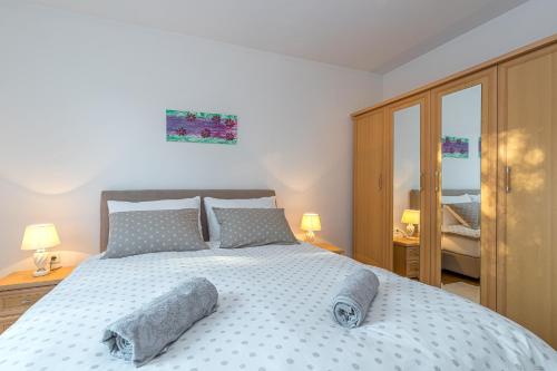 a bedroom with a large bed with two pillows on it at Apartment Percic with Shared Pool in Vabriga