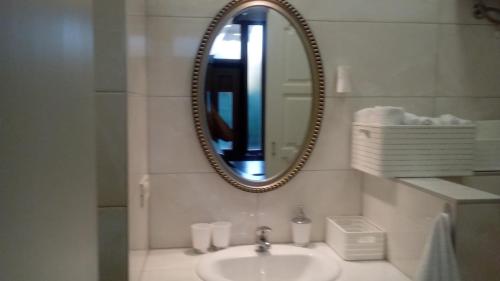 a bathroom with a sink and a mirror at Apartmani Belvedere in Novigrad Istria