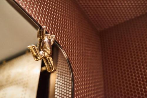 a gold object is attached to a wall at Andaz Prague, By Hyatt in Prague