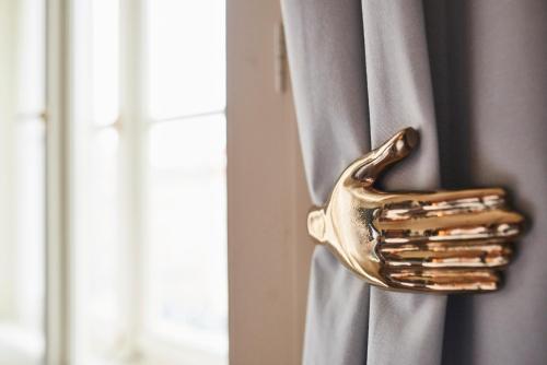 a gold fork sticking out of a window curtain at Andaz Prague, By Hyatt in Prague