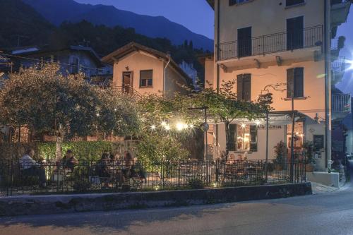 a group of people sitting at a table in front of a building at La Corte del Governo 565 in Lezzeno