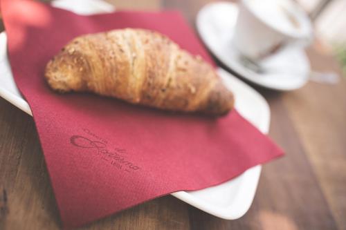 a piece of bread sitting on a red napkin at La Corte del Governo 565 in Lezzeno
