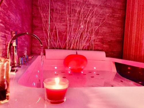a candle sitting on a counter next to a sink at YourHome - La Meta Perfetta Rooms&Spa in Meta