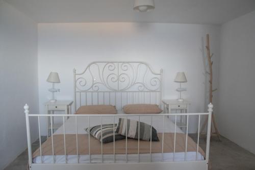 a bedroom with a white bed with two night stands at Villa Molos in Molos Parou