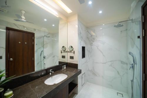 a bathroom with a sink and a shower at Aura Boutique Hotel in Udaipur
