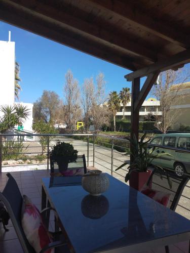 a blue table with a vase on a patio at Cozy Home (close to the beach) in Nea Kydonia