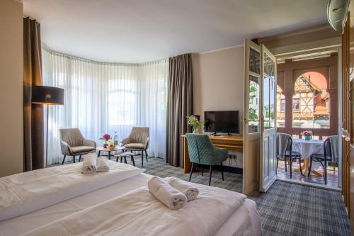 ein Hotelzimmer mit einem Bett und einem Wohnzimmer in der Unterkunft Sax Imperial in Dresden