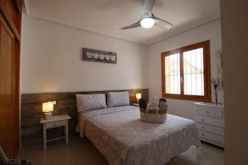 a bedroom with a bed and two lamps and a window at Ferienhaus mit Privaten Pool in Alicante