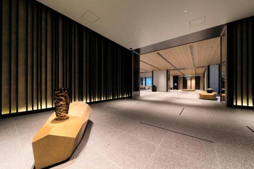 a lobby with a vase on a bench in a building at Richmond Hotel Premier Kyoto Shijo in Kyoto