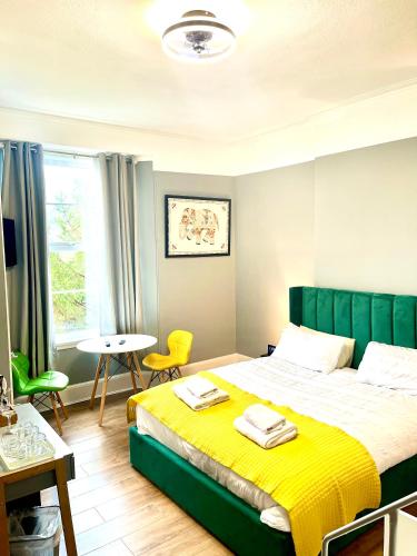a bedroom with a large bed and a table at The Westbank in Torquay