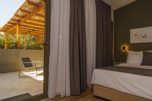 a bedroom with a bed and a sliding glass door at Vagabond Guesthouse in Athens