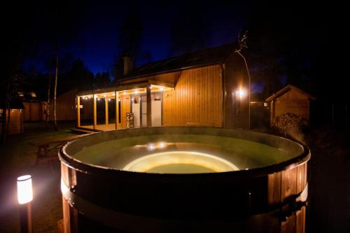 a bath tub in front of a building at night at Winiec Family Houses in Winiec