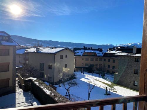 a view of a city in the snow from a balcony at Espléndida casa en el centro de Llivia con piscina in Llivia