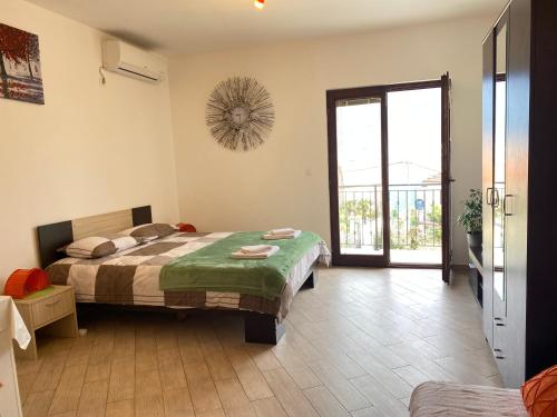a bedroom with a bed and a door to a balcony at Apartments Darija in Kotor