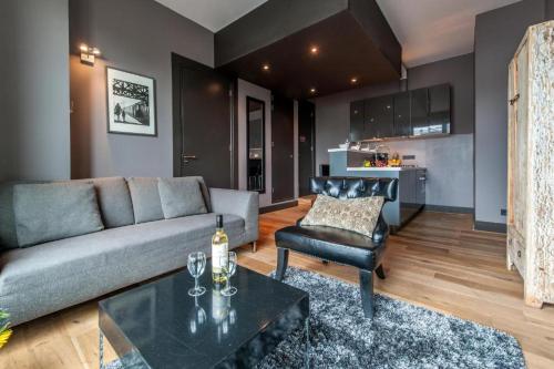 a living room with a couch and a table at Hotel Mosaic Apartments in Amsterdam