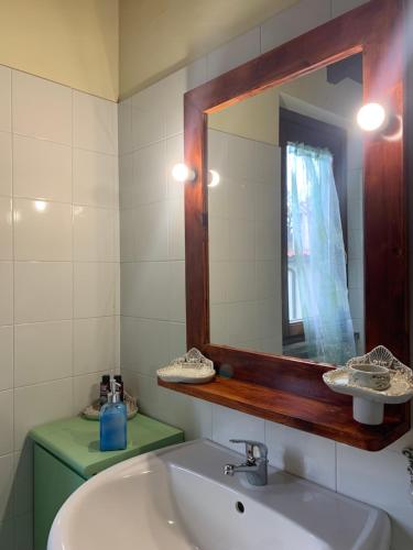a bathroom with a sink and a mirror at Antico Casale Edifizio -appartamento indipendente- in Viterbo