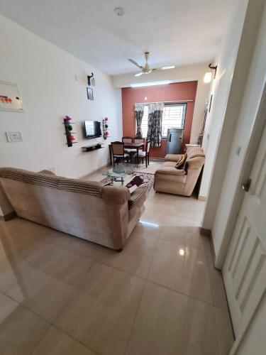 a living room with a couch and a table at S4 Sruthi Service Apartments in Chennai