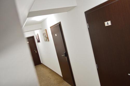 a hallway with two doors and a mirror at Penzion Batovka u Hoffera in Partizánske