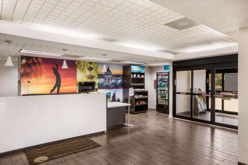 a large room with a large painting on the wall at Clarion Pointe Forsyth I-75 in Forsyth