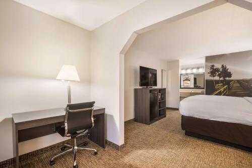 A bed or beds in a room at Clarion Pointe Forsyth I-75