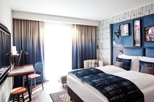 
a bedroom with a large bed and a large window at Hotel Indigo Berlin - East Side Gallery, an IHG Hotel in Berlin
