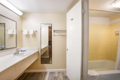 a bathroom with a sink and a shower at Rodeway Inn in Cecil