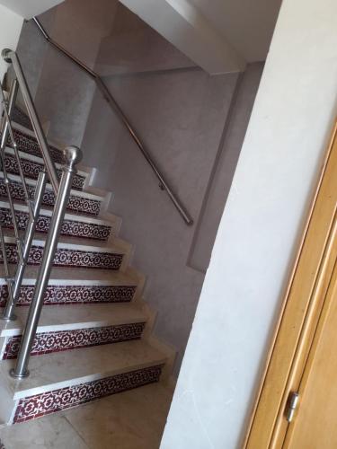 a staircase in a house with a metal railing at Atlantic Beach View Villa in El Jadida
