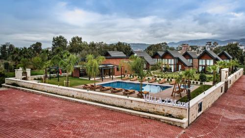a mansion with a swimming pool and a house at Villa d'Mare in Demre