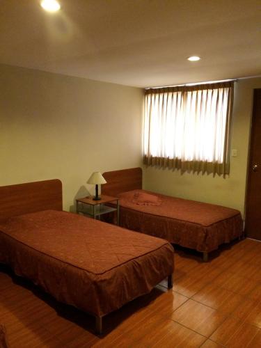 Letto o letti in una camera di Hotel Tito