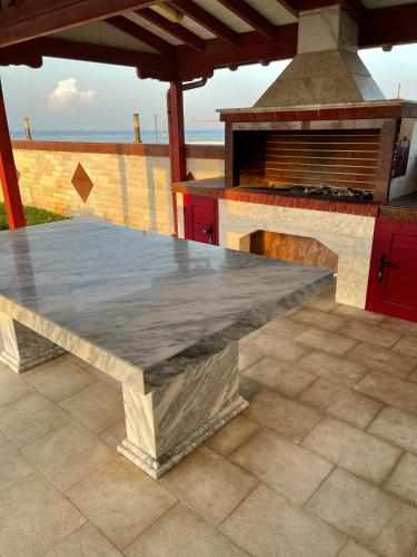a kitchen with a stone counter top and a stove at MESAGGALA PALACE No 1 !!! FIRSTLINE SEA in Néa Meságkala
