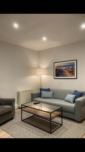 a living room with a couch and a coffee table at Relax by the Sea in Weymouth