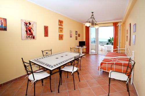 a dining room with a table and chairs at Polifemo in Letojanni
