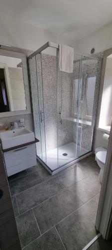 a bathroom with a shower and a sink and a toilet at Antica locanda al Gelso in Monfalcone