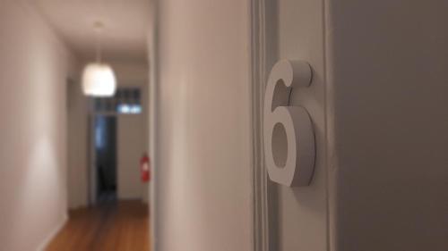 a door with a number on the side of a room at A Casa do Tenente in Faro