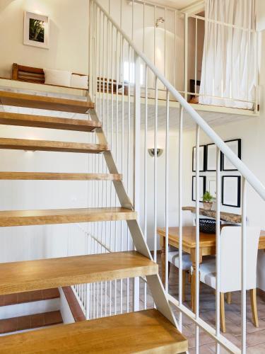 a staircase in a house with wooden stairs and a table at Podere Gattabigia in Lastra a Signa