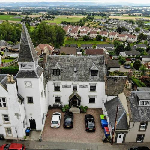 an aerial view of a large white house with cars parked at The Tower Gastro Pub & Apartments in Crieff