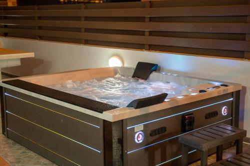 a hot tub with a chair in front of it at Seafront Protaras Villas in Protaras