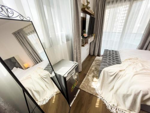 a mirror in a bedroom with a bed at Luxury Room with Marina view close to JBR Beach and Metro with Shared Kitchen in Dubai