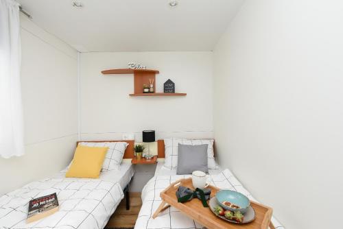 a living room with a couch and a table at MIA mobile home with jacuzzi in Ždrelac