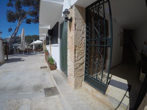 an entrance to a building with a wrought iron gate at Hostal Playa in Cala Santanyi