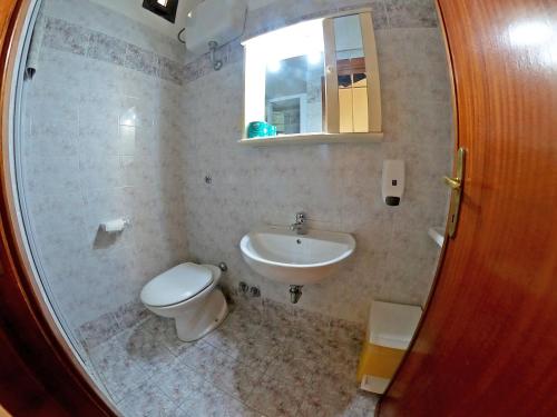 a bathroom with a toilet and a sink at Gallura Hotel in Santa Teresa Gallura