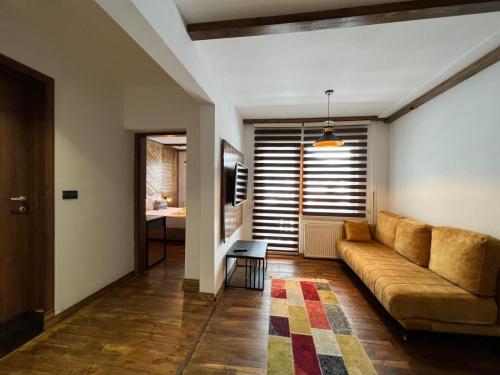 a living room with a couch and a table at Mia's Favorite Hotel in Mavrovo