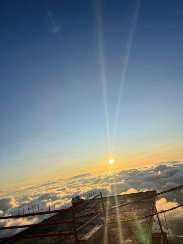 a view of the sun rising over the clouds at White House Bungalow Hatton in Hatton
